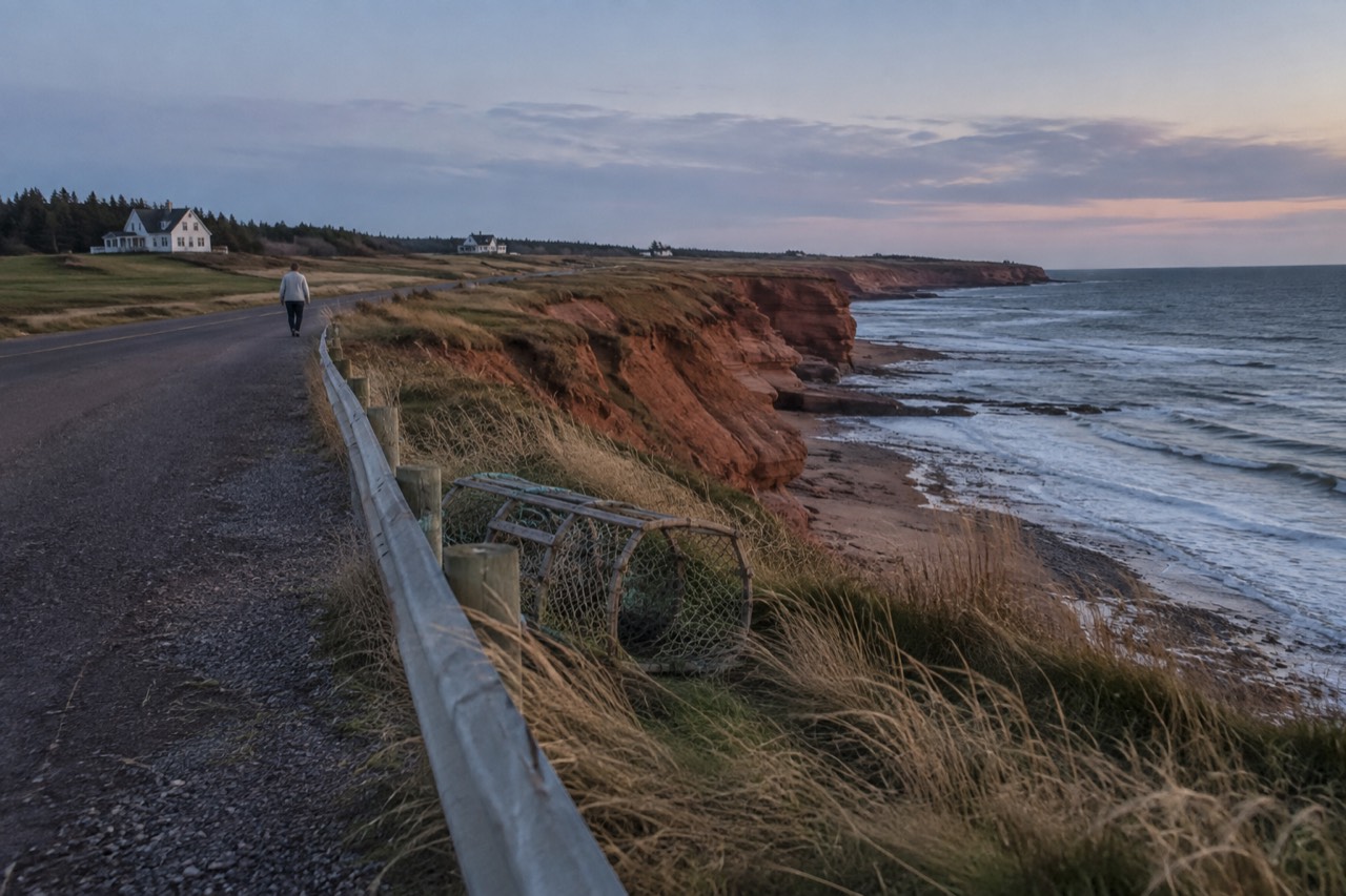 Red sandstone cliffs and a quiet coastal road on Prince Edward Island