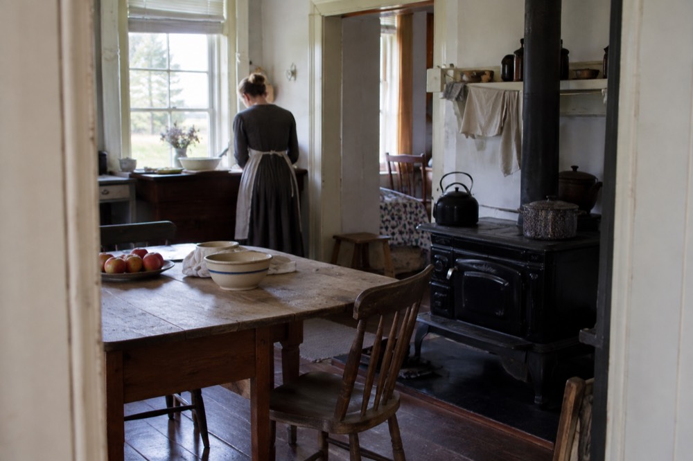 Farmhouse kitchen interior with period furniture and a wood stove