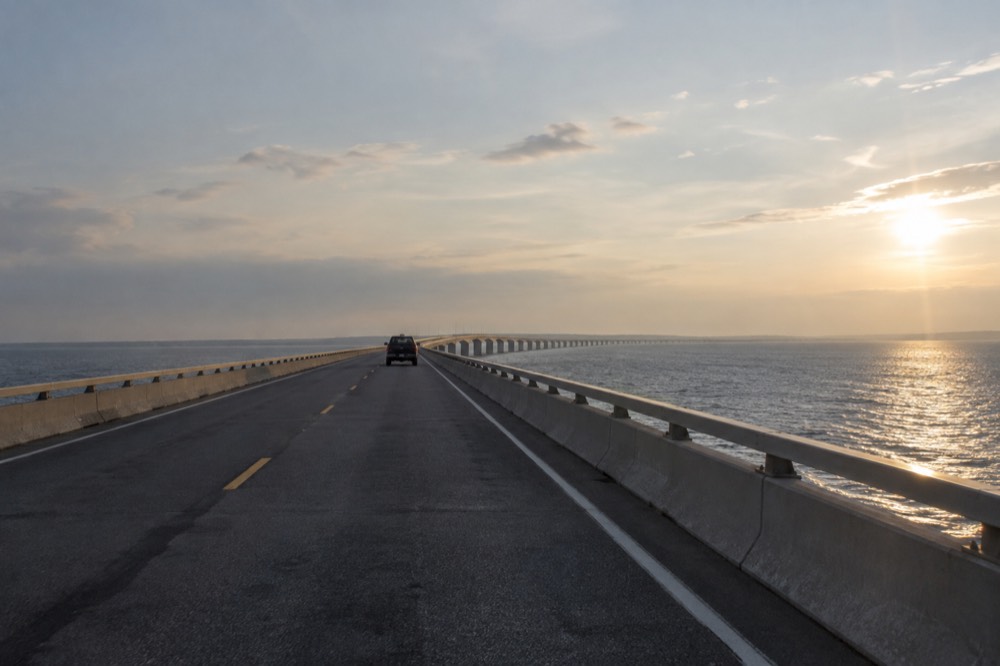 A road stretching across the Confederation Bridge over open water