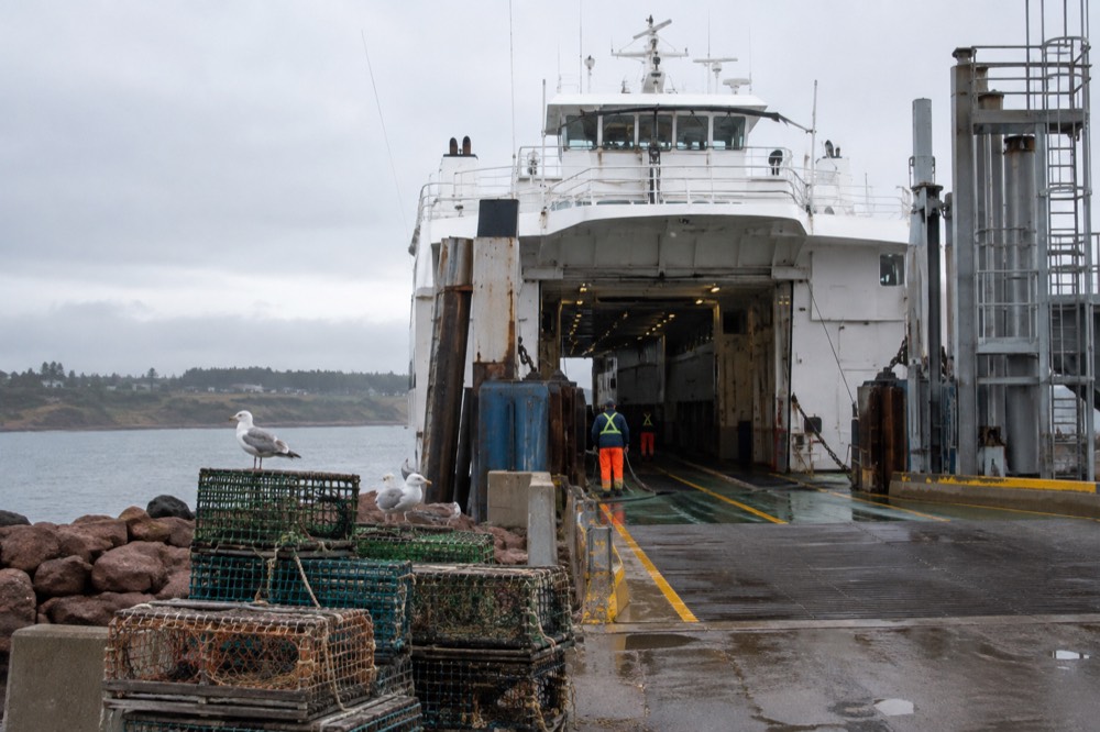 A ferry vessel docked at a small Island harbour terminal
