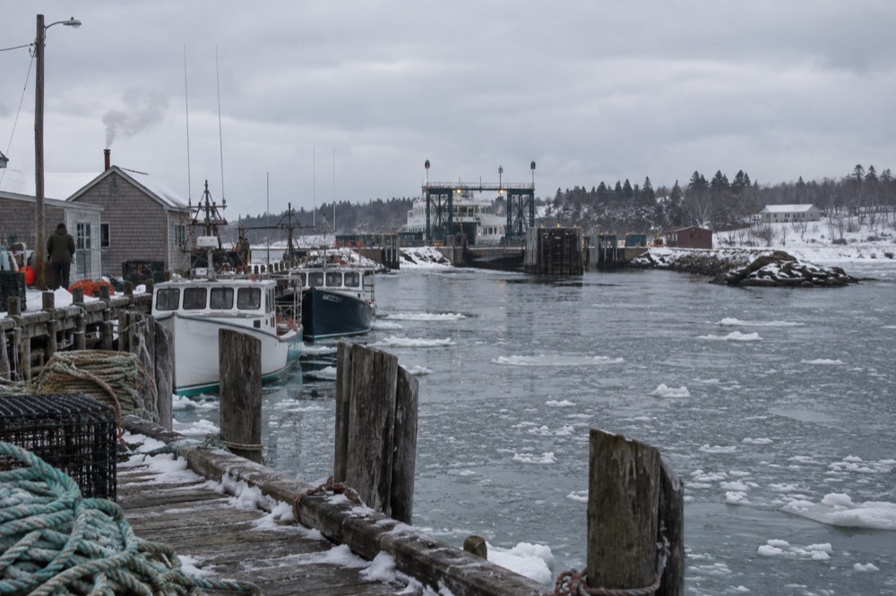 A fishing harbour with lobster boats moored at wooden wharves
