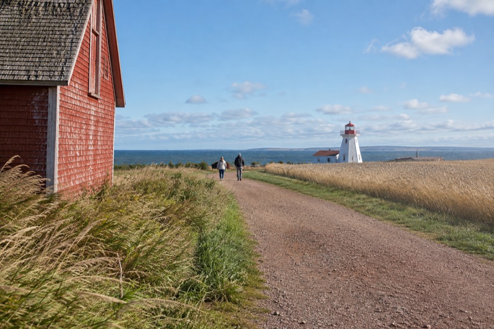 A bicycle trail passing beside a red barn and rolling farm fields
