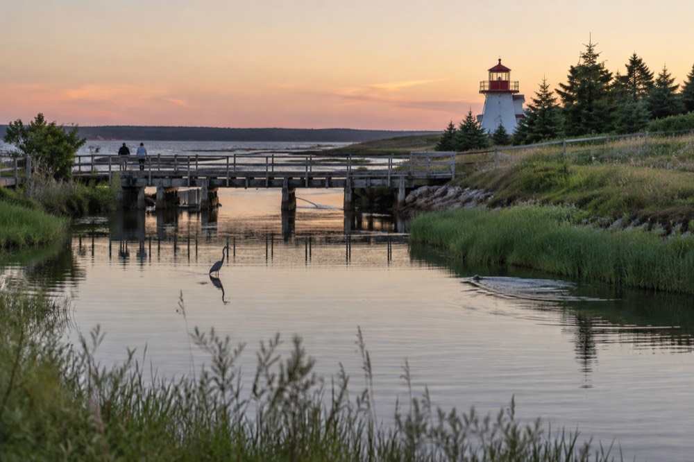 A trailside view of a quiet Prince Edward Island river channel reflecting the sky
