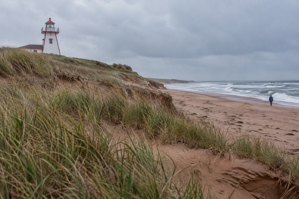 White and red sand dunes with a lighthouse on the Prince Edward Island coast