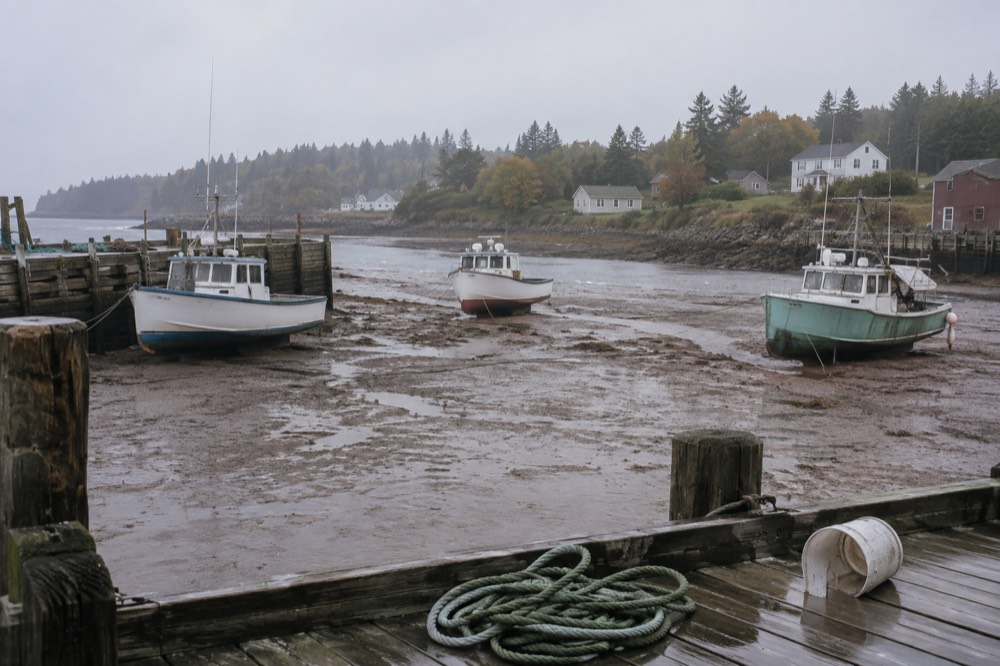 Fishing boats moored in a small Island harbour at low tide