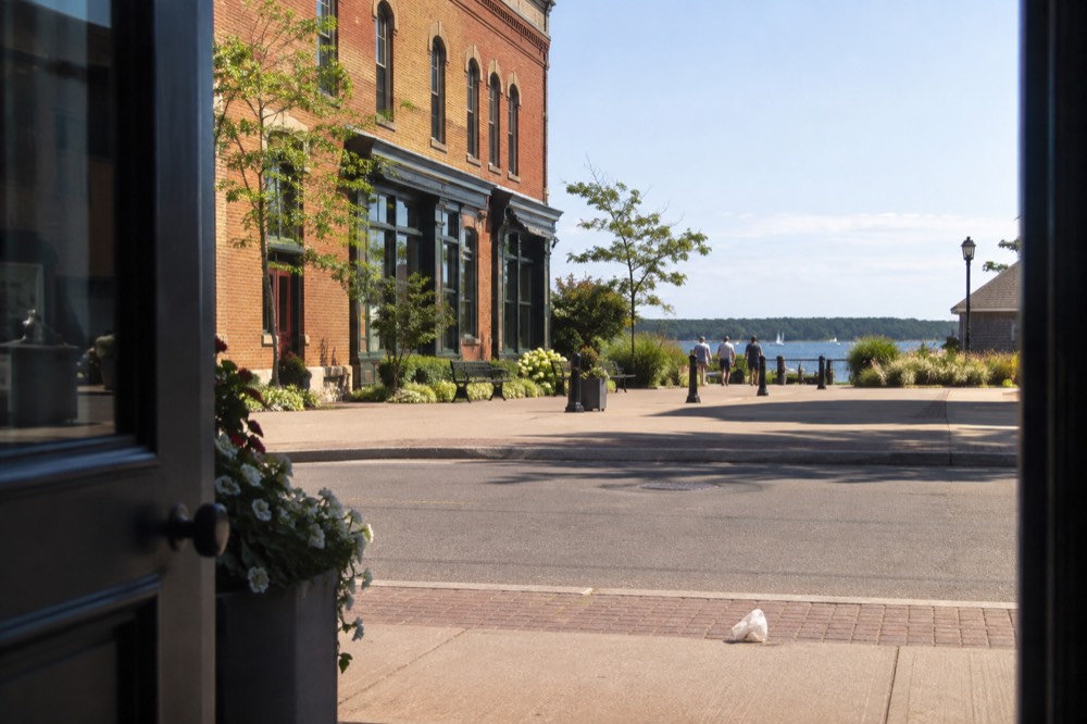 Historic brick storefronts along a Charlottetown street with the harbour beyond
