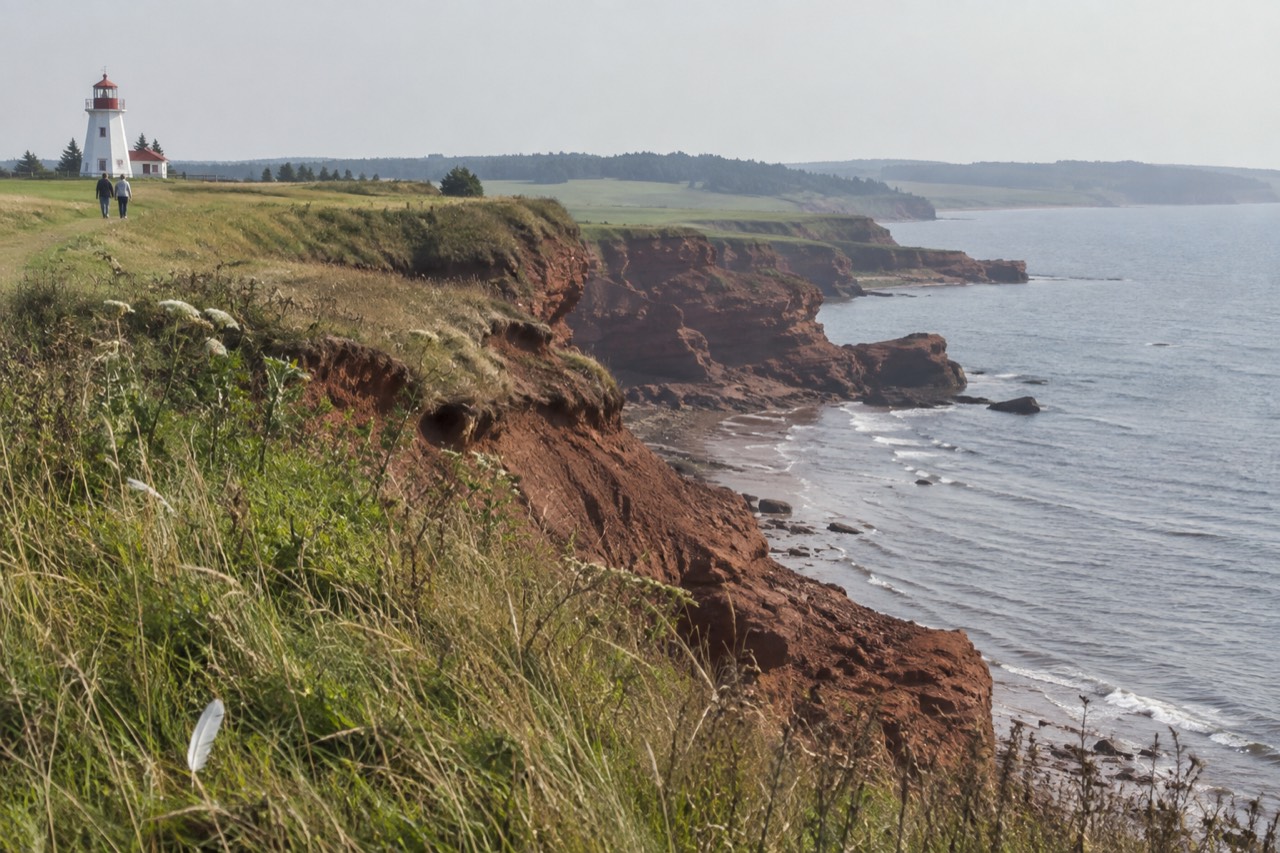 Red sandstone cliffs and rolling green farmland along a quiet Island road