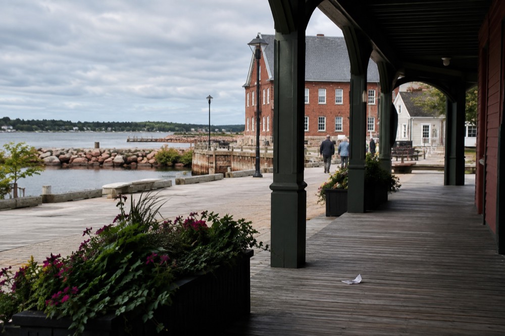 Historic brick and clapboard buildings along a Charlottetown waterfront street