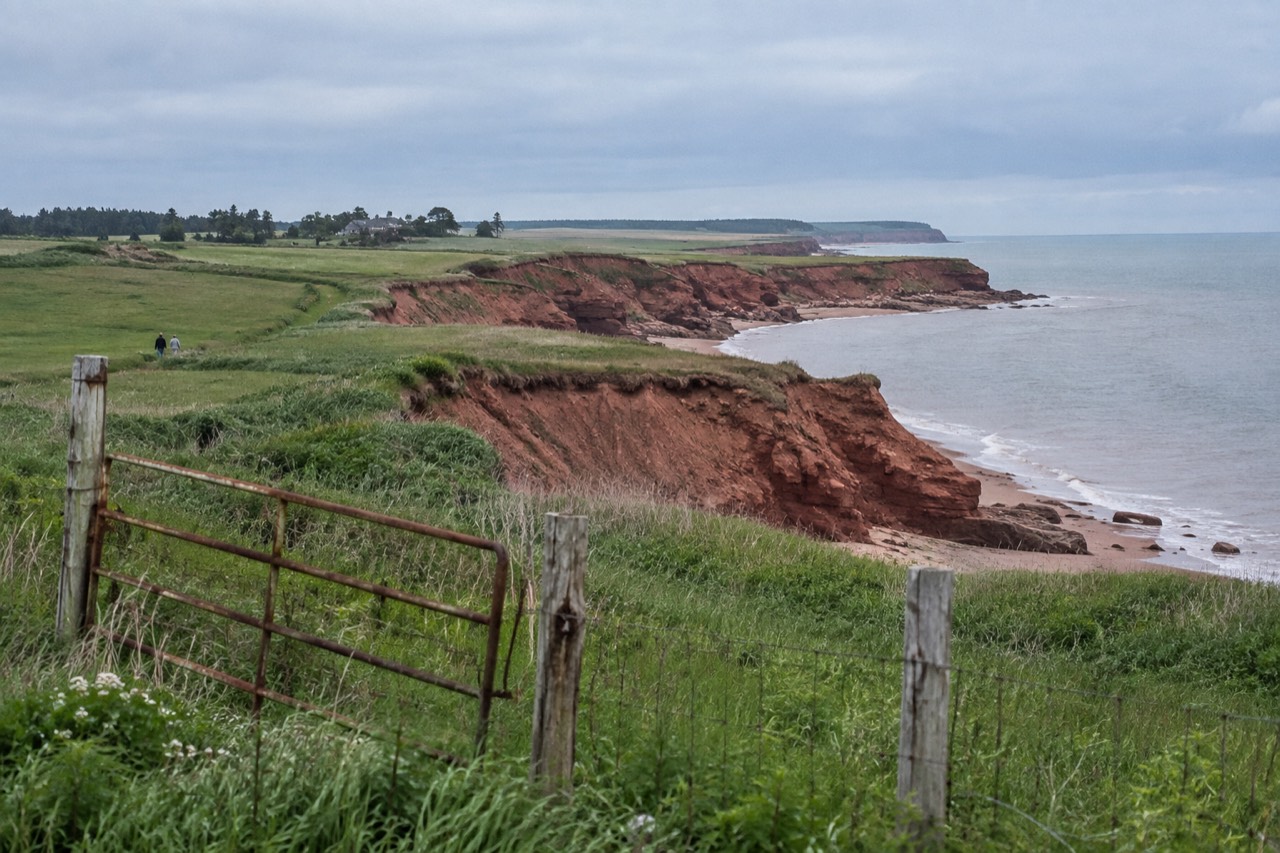 Red sandstone cliffs and rolling green farmland along the Prince Edward Island coast
