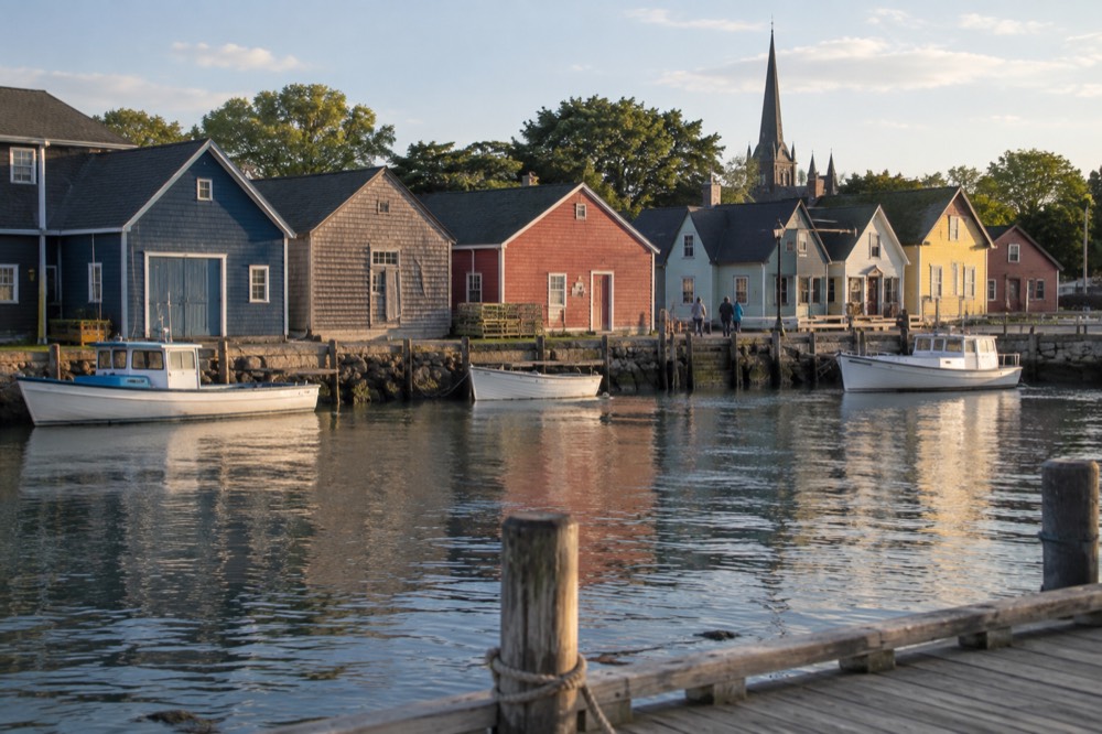 A harbour village street with colourful waterfront buildings on a calm afternoon