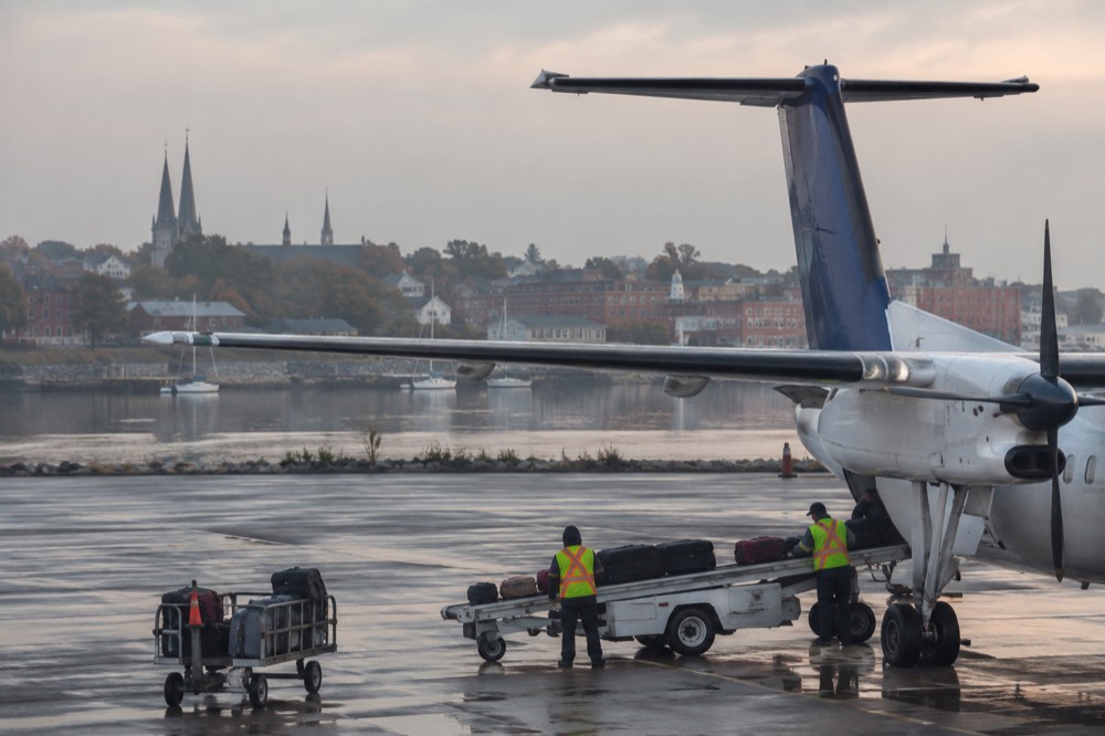 A small regional airliner on the tarmac at Charlottetown Airport under a wide sky