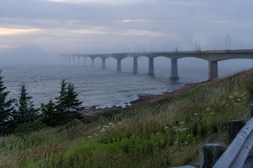 The long curved span of the Confederation Bridge seen from the PEI shore at dusk