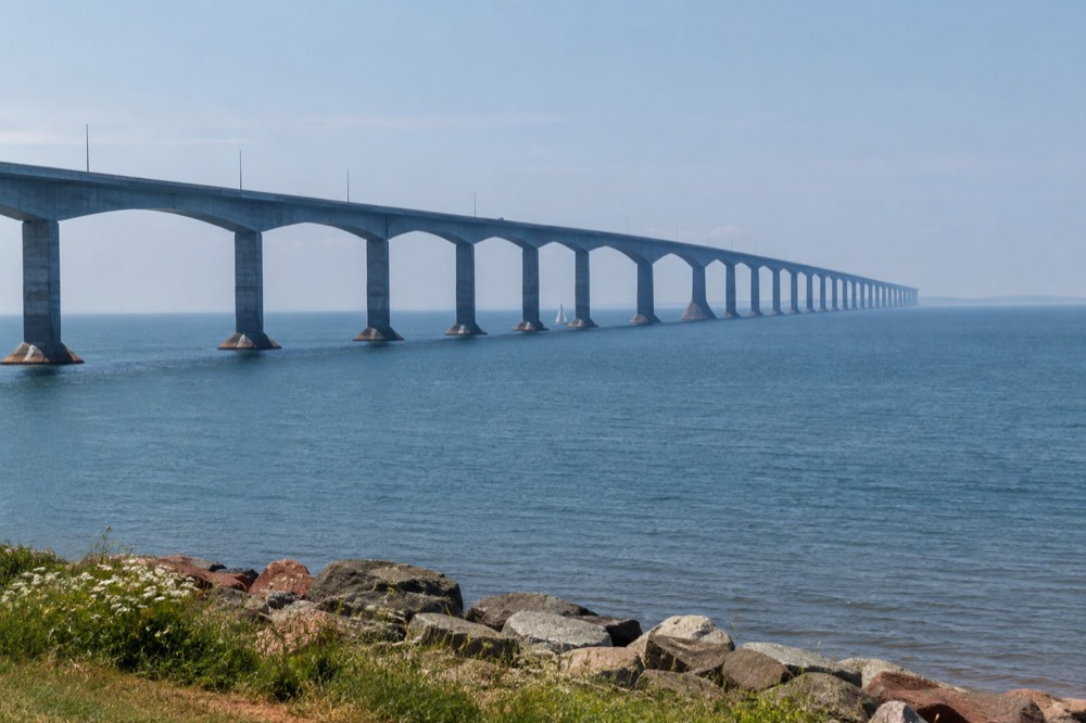 The long curve of a fixed-link bridge crossing open blue water