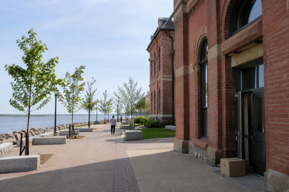 A harbourfront street with historic brick buildings at midday