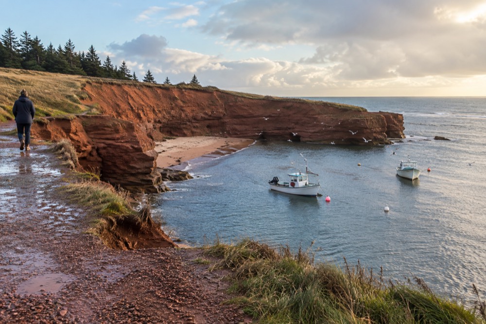 Red cliffs and fishing boats along a Prince Edward Island shoreline